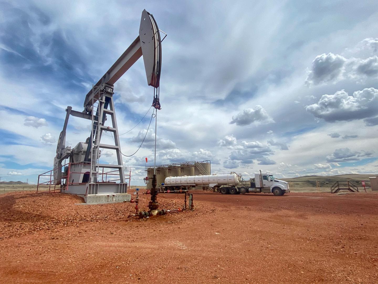 Bell Energy tanker truck working beside a pumpjack at a Bakken production site